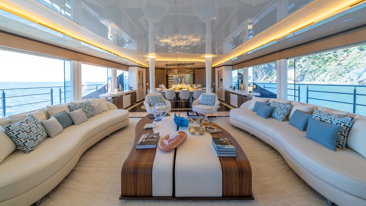 CAMILA main saloon — two curved Sitdesign sofas facing each other with swivel armchairs between them