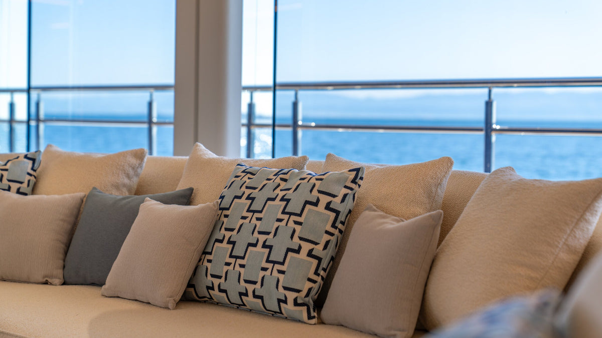 Detail of a Sitdesign sofa on CAMILA — bouclé upholstery and patterned cushions