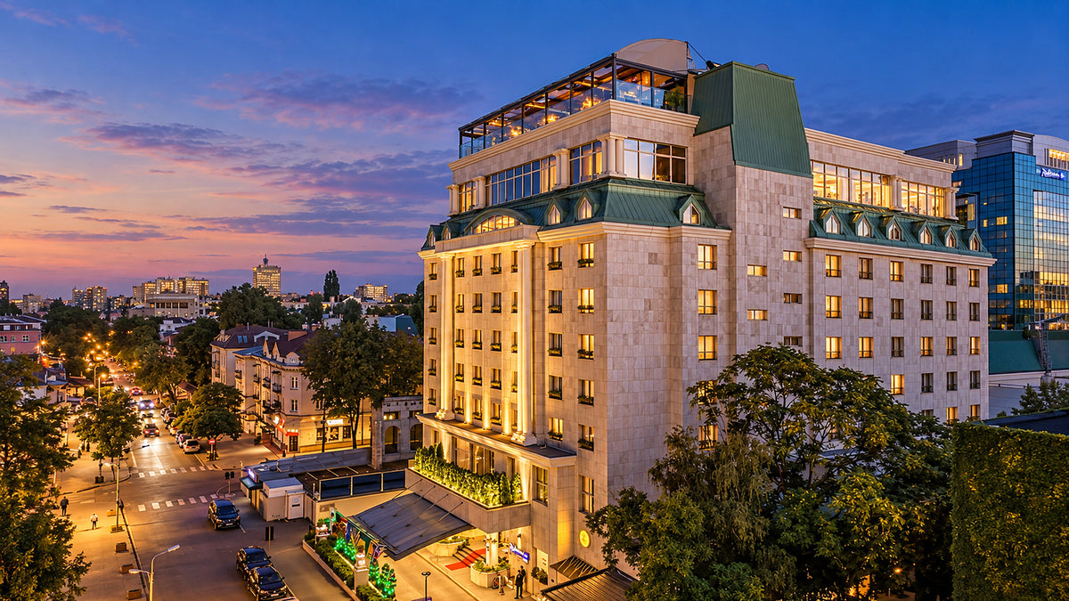 Radisson Blu Leogrand hotel at dusk with its rooftop restaurant lit, Chișinău, Moldova