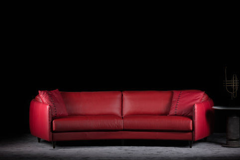 Janette Curved sofa photographed against a dark background