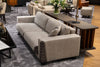 Upholstered sofa with a woven leather arm detail