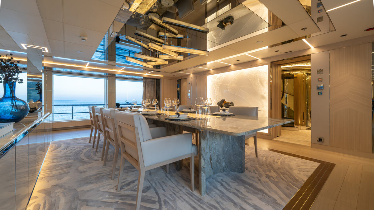 Al Reem main saloon dining table with upholstered chairs by Sitdesign