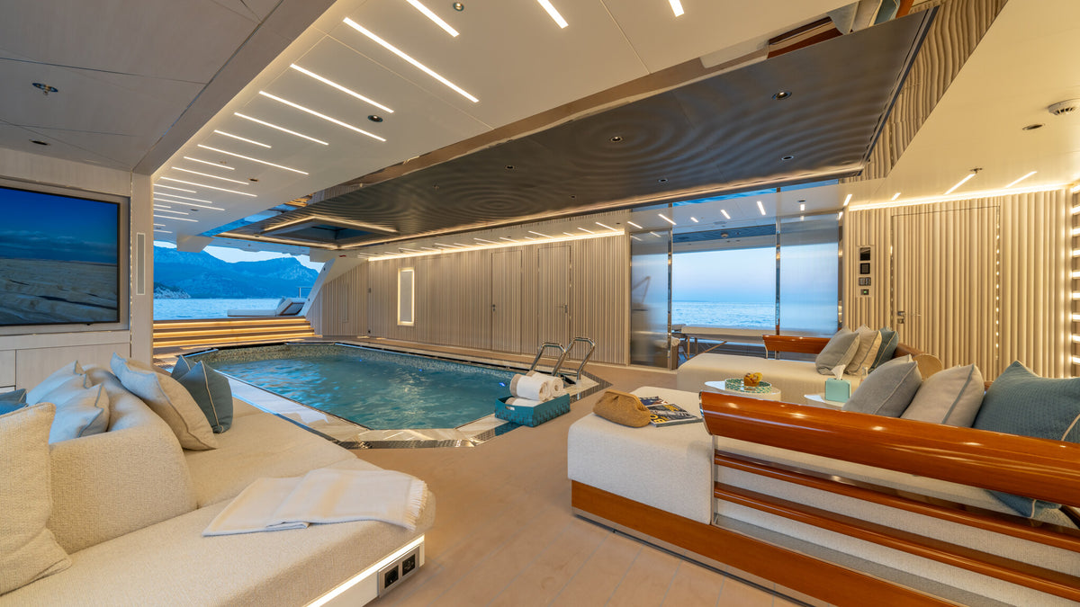 Al Reem beach club — low seating beside the pool, built for sun and salt air