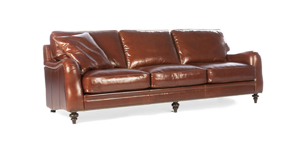 Chelsea sofa in cognac leather with rolled arms, nailhead trim and turned wooden legs, three-quarter view