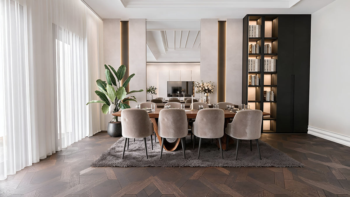 Oval walnut dining table with velvet chairs and lit black library wall, Göl İstanbul villa