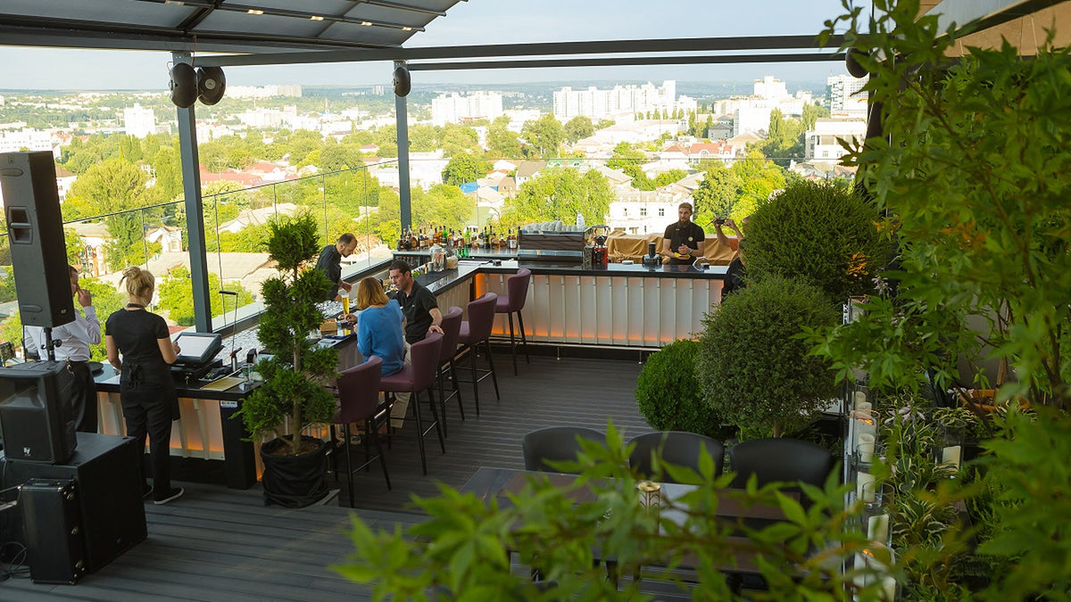 Rooftop terrace bar with upholstered bar stools above the city, Radisson Blu Leogrand