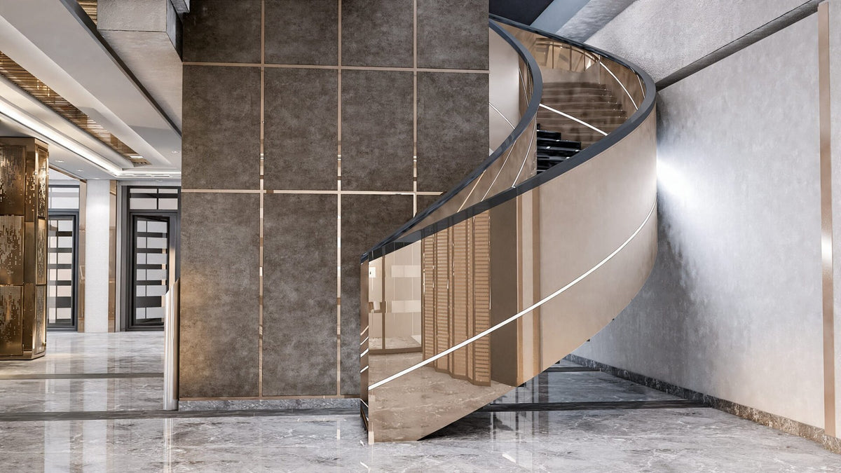 Curved bronze and glass staircase in the Sanel Asansör entrance lobby — Sitdesign