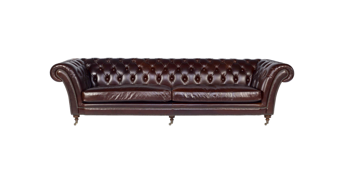Jakarta chesterfield sofa in oxblood leather with button-tufted back, rolled arms, nailhead trim and turned legs on castors, front view