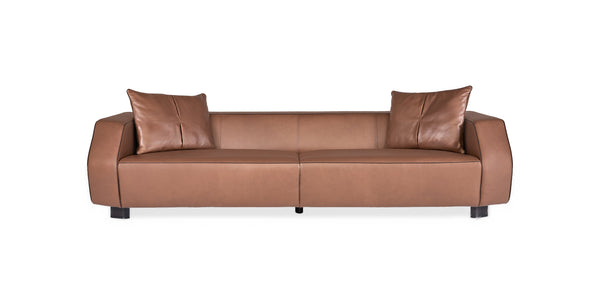 Nova sofa in tan leather with rounded arms and two scatter cushions, front view