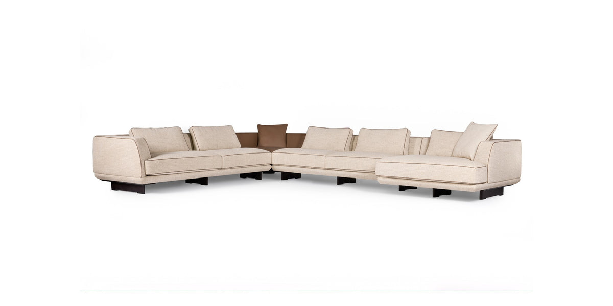 Ranchero sectional sofa in cream fabric with brown accent cushions, front view