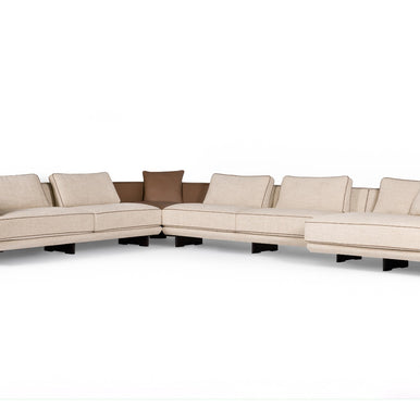 Ranchero sectional sofa in cream fabric with brown accent cushions, front view