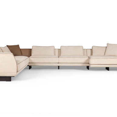 Ranchero sectional sofa in cream fabric with brown accent cushions, corner view
