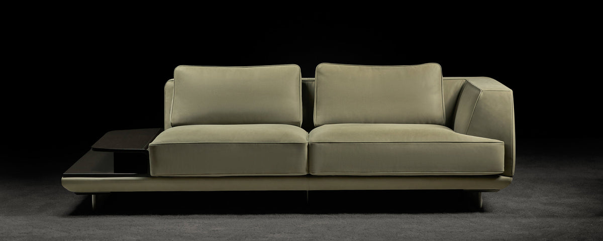 Ranchero sofa photographed against a dark background, wide view